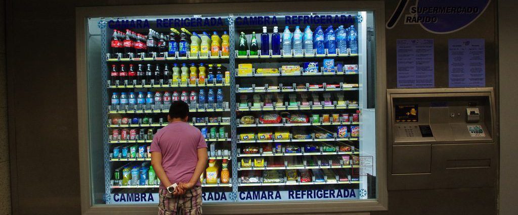 Man standing in front of large vending machine