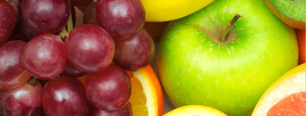 Close up of various fruit including apples and grapes